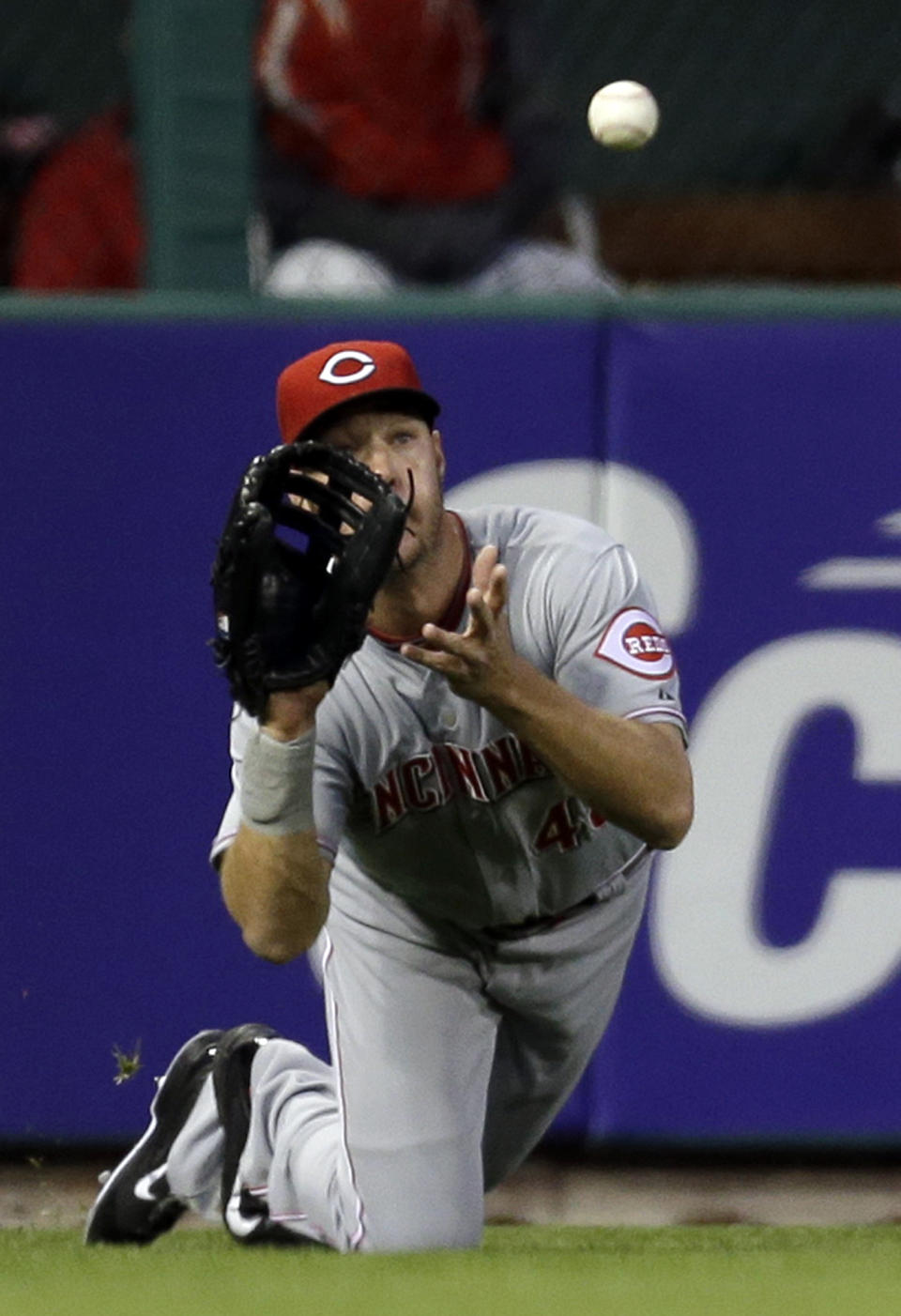 Cincinnati Reds left fielder Ryan Ludwick dives and catches a ball hit by St. Louis Cardinals' Matt Carpenter for an out during the first inning of a baseball game Tuesday, April 8, 2014, in St. Louis. (AP Photo/Jeff Roberson)