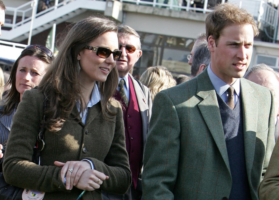 Britain's Prince William (R) stands beside girlfriend Kate Middleton (L) in the paddock enclosure on the first day of the Cheltenham Race Festival at Cheltenham Race course, in Gloucestershire 13 March 2007. (Photo credit should read CARL DE SOUZA/AFP via Getty Images)