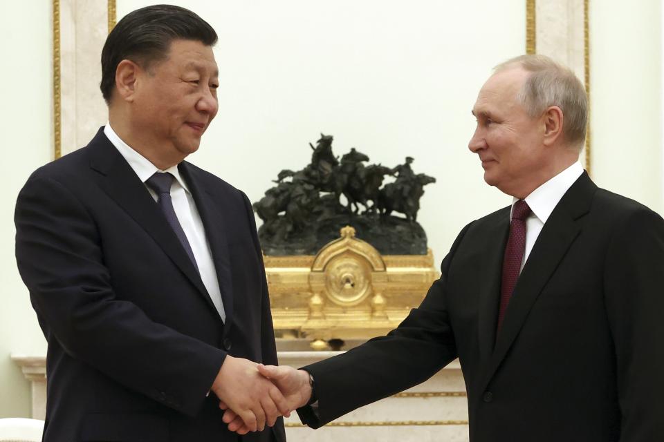 Chinese President Xi Jinping, left, and Russian President Vladimir Putin shake hands during their meeting at the Kremlin in Moscow, Russia, Monday, March 20, 2023. (Sergei Karpukhin, Sputnik, Kremlin Pool Photo via AP)