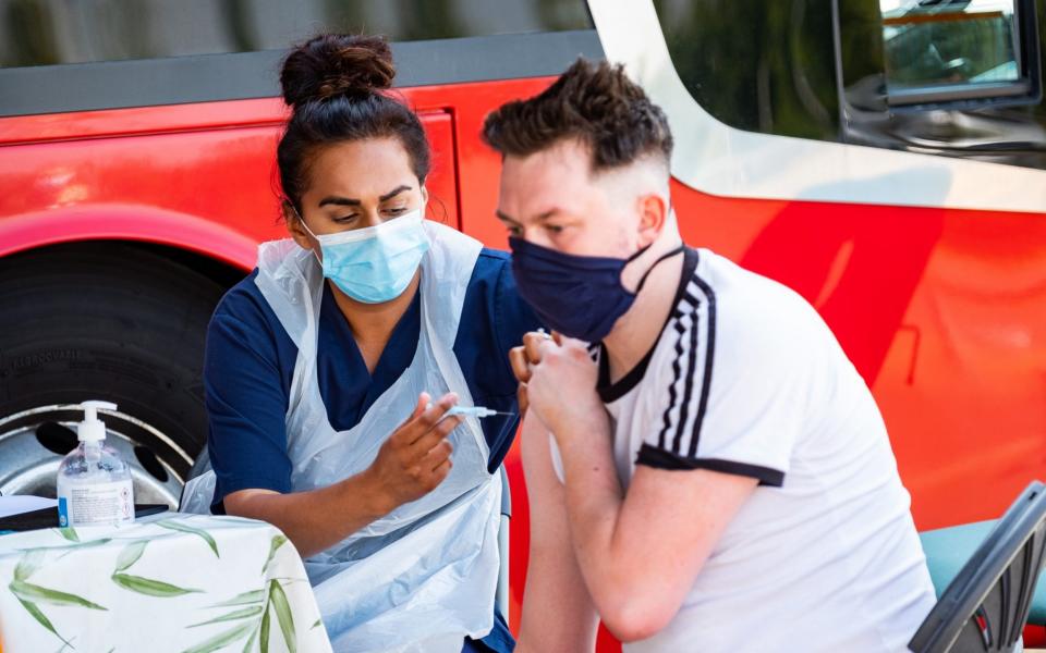 Jon Davie, 29, receiving his vaccination at the Covid bus, Celtic Park, Glasgow - Jon Davie, 29, receiving his vaccination at the Covid bus, Celtic Park, Glasgow