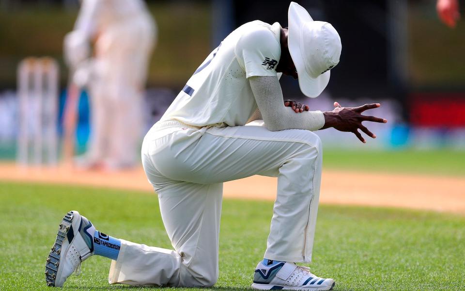 England's paceman Jofra Archer stretches his hand after stopping the ball on day four of the second cricket Test match between England and New Zealand at Seddon Park in Hamilton on December 2, 2019 - AFP/David Gray