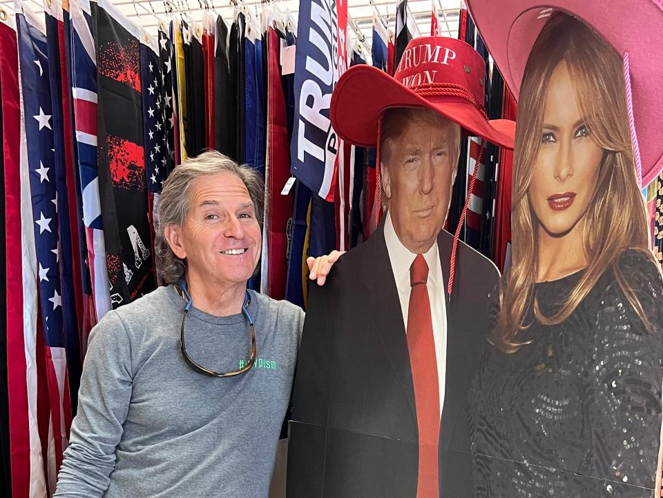 Richard Kligman with Donald and Melania Trump cutouts.