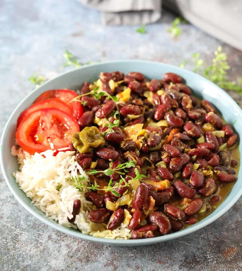 Large plate filled with kidney bean curry, white rice, and tomato slices.