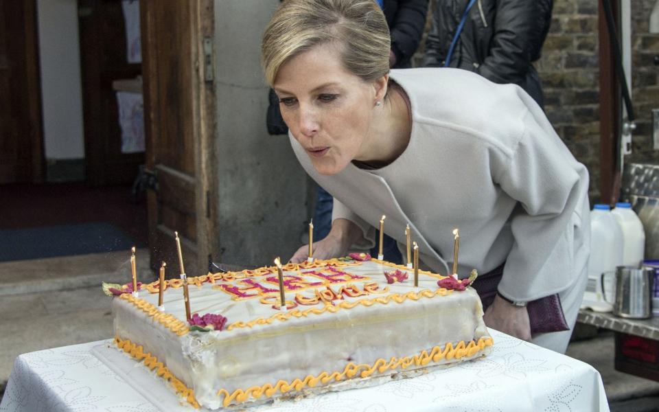 Sophie, Countess of Wessex, blows out the candles on a cake to celebrate her 50th birthday  - Credit: ARTHUR EDWARDS,/AFP