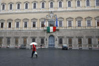 In this photo taken March 27, 2020, the Italian flag hangs from the balcony of the French Embassy in Rome. From tiny San Marino wedged next to two of Italy's hardest-hit provinces in the coronavirus outbreak to more economically powerful nations like Italy, countries are running up against export bans and seizures in the scramble for vital medical supplies. The new coronavirus causes mild or moderate symptoms for most people, but for some, especially older adults and people with existing health problems, it can cause more severe illness or death. (AP Photo/Alessandra Tarantino)