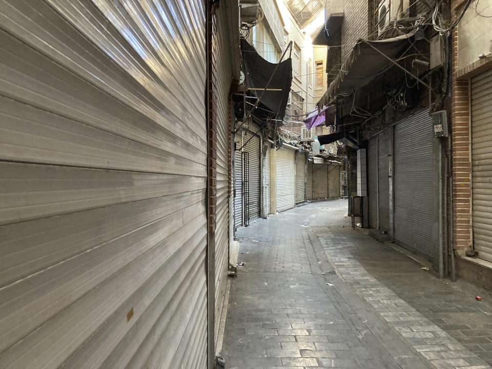 Closed shops are seen at Tehran's Grand Bazaar, Iran, Tuesday, Nov. 15, 2022. Many shops at Grand Bazaar in Iran's capital city were closed Tuesday amid strike calls following the September death of a woman who was arrested by the country's morality police. (AP Photo/Vahid Salemi)