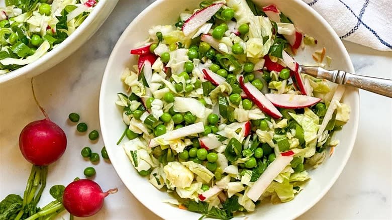 Summer pea salad in white bowl