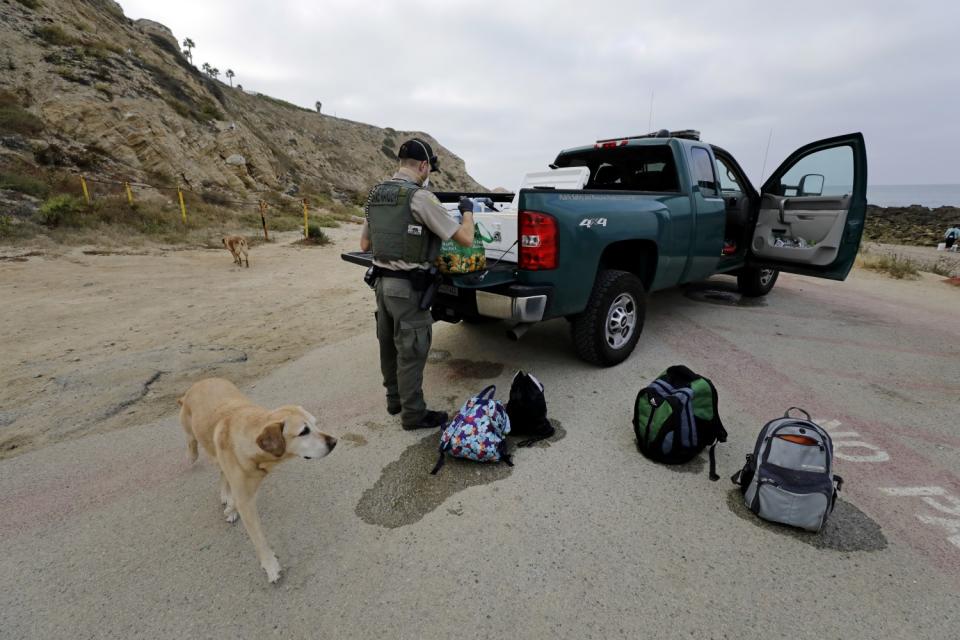 Game warden Doug Wall confiscates bags of mussels.