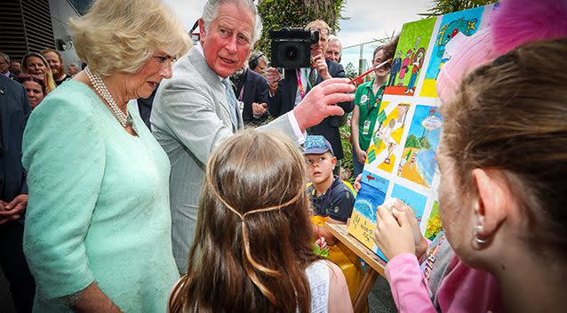 Prince Charles adds his finishing touch to a children's painting with Camilla, Duchess of Cornwall during his official visit to the Lady Cilento Children's Hospital in Brisbane on Wednesday. Source: AAP