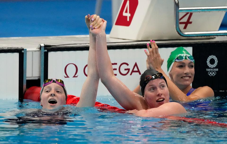 Lydia Jacoby (USA), Tatjana Schoenmaker (South Africa) and Lilly King (USA) react after finishing first, second and third in the women's 100-meter breaststroke.