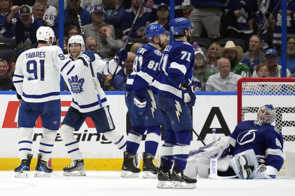 Toronto Maple Leafs center Calle Jarnkrok (19) celebrates with center John Tavares (91) after scoring against the Tampa Bay Lightning during the second period of an NHL hockey game Tuesday, April 11, 2023, in Tampa, Fla. (AP Photo/Chris O'Meara)
