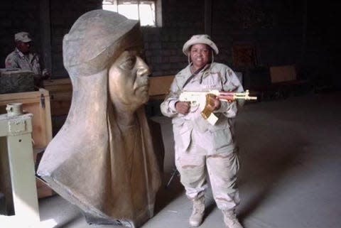 Veronica Miller guarding Hussein's golden weapons in Iraq.