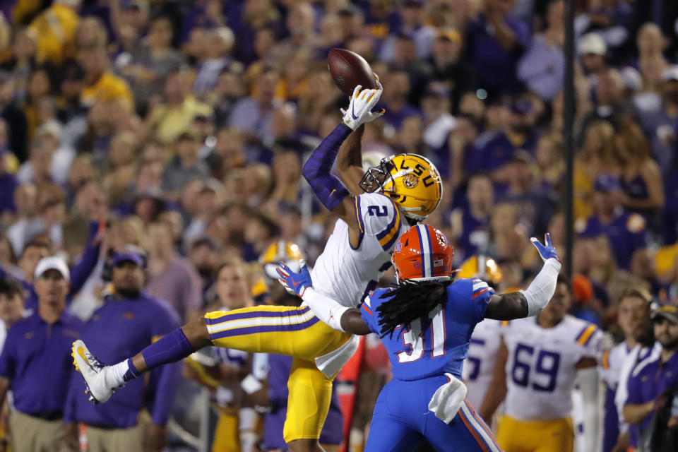 LSU wide receiver Justin Jefferson (2) catches a pass over Florida defensive back Shawn Davis (31) in the first half of an NCAA college football game in Baton Rouge, La., Saturday, Oct. 12, 2019. (AP Photo/Gerald Herbert)