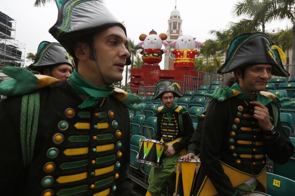 Drummers from France rest during a rehearsal ahead of a Lunar New Year night parade in Hong Kong