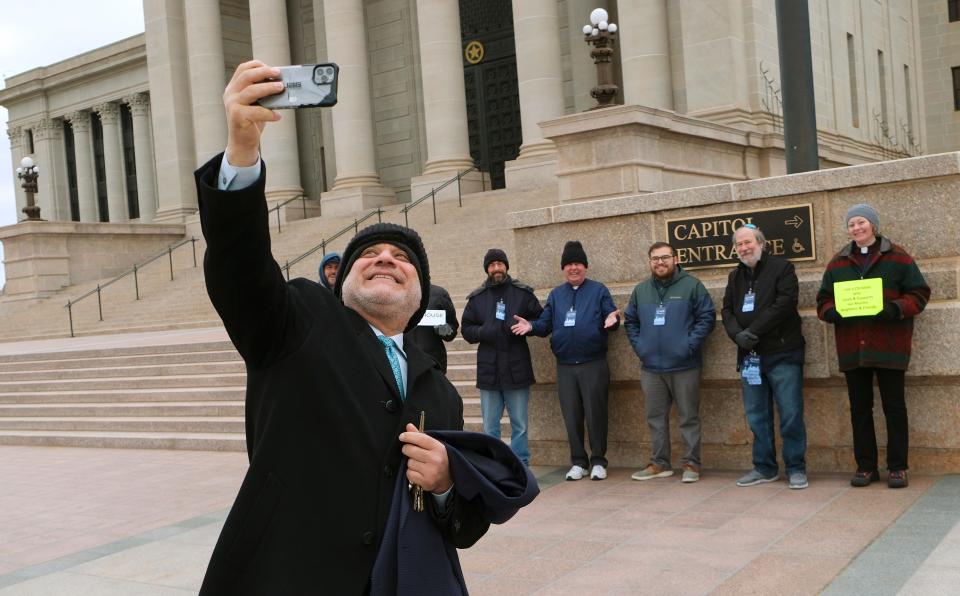 Imam Imad Enchassi takes a selfie Monday with members of the interfaith community who showed up to support and welcome Muslims during Muslim Day at the Oklahoma Capitol.