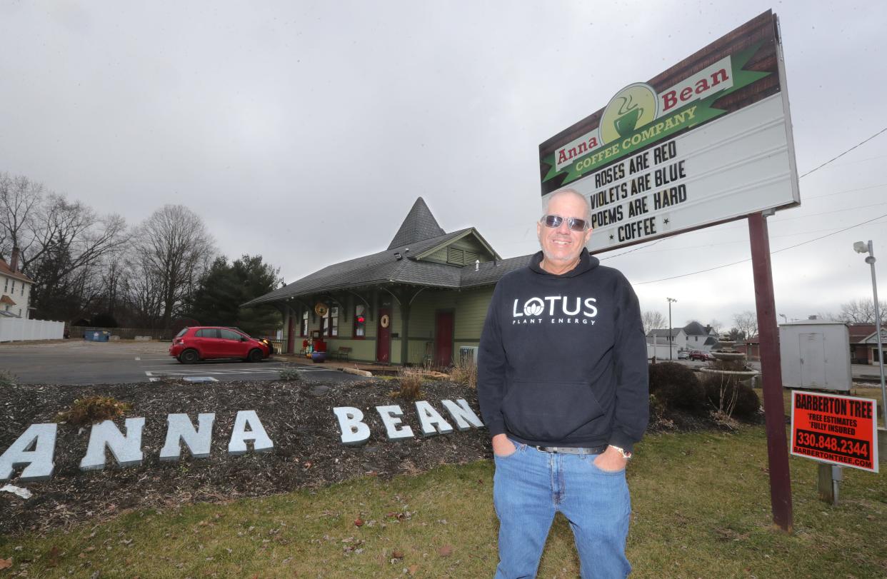 Jeremy Clemetson, owner of the Anna Bean Coffee Company, stands in front of the company's sign Monday in Barberton.