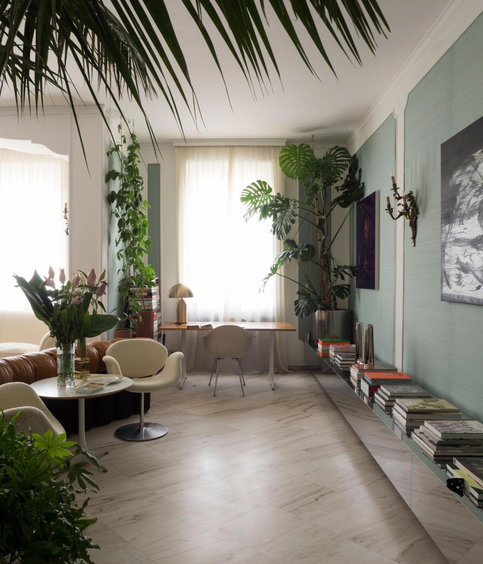 The low metal bookshelf was custom made to hold Werz’s vast collection of magazines; the planters and greenery were designed by Derek Castiglioni, who added botanical accents throughout the apartment.