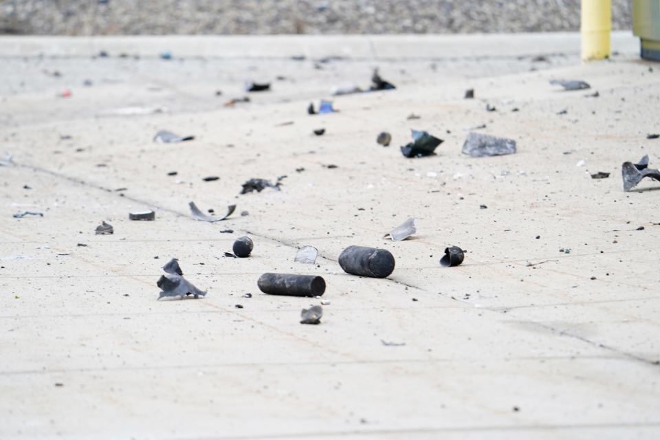 Metallic debris including several tanks litter a parking lot across from Select Distributors in Clinton Township where multiple explosions ripped through the building at 15 Mile Road during the evening on Monday, March 4, 2024.