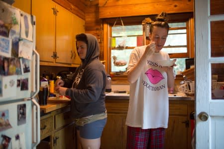 Quail Hill farmers Layton Guenther and Alicia Mountain eat breakfast at home before the day's farm work in Amagansett