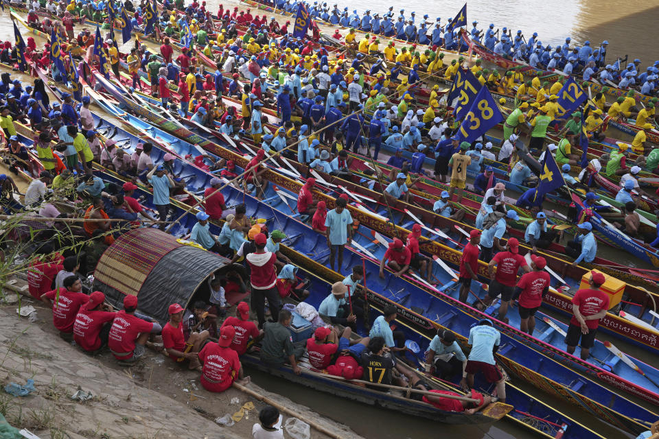 Cambodian rowers wait beside their boats before participating in a water festival in Phnom Penh, Cambodia, Sunday, Nov. 26, 2023. The annual three-day festival is dedicated to the kingdom's ancestral naval warriors. (AP Photo/Heng Sinith)