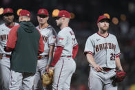 Arizona Diamondbacks starting pitcher Merrill Kelly, right, is pulled from the baseball game against the San Francisco Giants during the fifth inning in San Francisco, Friday, Sept. 30, 2022. (AP Photo/Godofredo A. Vásquez)