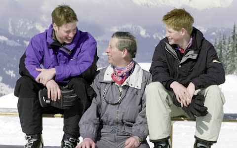 The Prince of Wales and his sons, Prince William (left) and Prince Harry, pose for photographers on the Madrisa ski slopes above Klosters - Credit: John Stillwell/PA