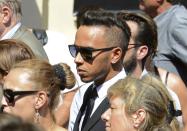 Formula One driver Lewis Hamilton leaves after the funeral ceremony for late Marussia F1 driver Jules Bianchi at the Sainte Reparate Cathedral in Nice, France, July 21, 2015. Bianchi, 25, died in hospital in Nice on Friday, nine months after his crash at Suzuka in Japan and without regaining consciousness. REUTERS/Jean-Pierre Amet