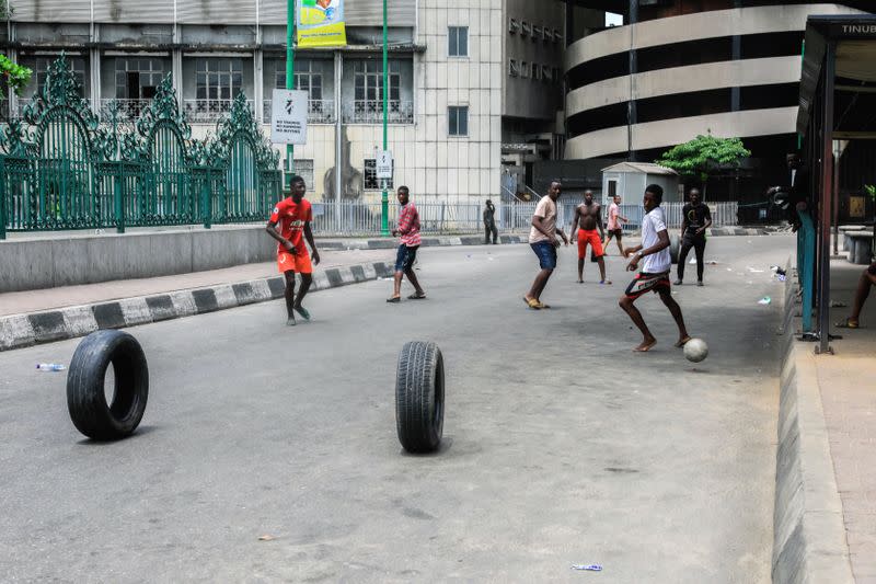 Boys play football in the central business district on the first day of a 14-day lockdown aimed at limiting the spread of coronavirus disease (COVID-19) in Lagos