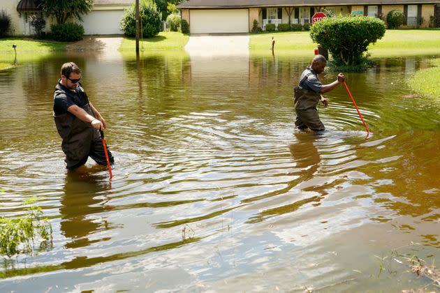 Hinds County Emergency Management Operations deputy director Tracy Funches, right, and operations coordinator Luke Chennault, wade through flood waters in northeast Jackson, Mississippi, on Monday. (Photo: Rogelio V. Solis via AP)