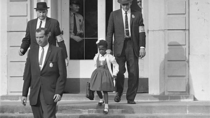 U.S. deputy marshals escort 6-year-old Ruby Bridges from William Frantz Elementary School in New Orleans in this file photo from Nov. 14, 1960. Bridges has authored a picture book to explain that long-ago experience to the youngest readers. (Photo: AP/File)