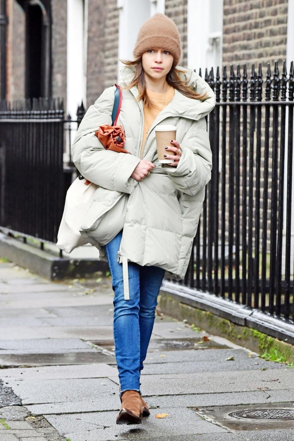 <p>Emilia Clarke keeps warm under a beanie and a chic puffer coat while out and about in London on Sunday.</p>