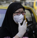 A woman wears a mask outside a hospital that also has a special ward set aside for possible COVID-19 patients, in Mumbai, India, Thursday, March 5, 2020. A new virus first detected in China has infected more than 90,000 people globally and caused over 3,100 deaths. The World Health Organization has named the illness COVID-19, referring to its origin late last year and the coronavirus that causes it. (AP Photo/Rajanish Kakade)