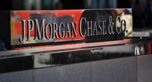 The JPMorgan Chase & Co. logo is displayed at the company's offices in New York, U.S., on Friday, May 17, 2013. As JPMorgan Chase & Co.?s Jamie Dimon prepares for a vote tomorrow on whether he should keep his chairman and chief executive officer titles, he may take comfort knowing most of his biggest shareholders are led by men with the same dual role. Photographer: Victor J. Blue/Bloomberg via Getty Images