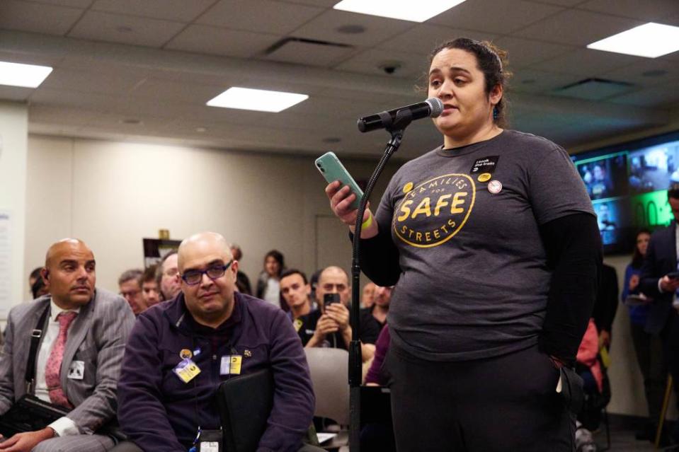 A woman who was struck by a vehicle speaks during the public hearing on Thursday. James Keivom