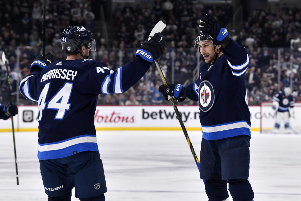 Winnipeg Jets' Nino Niederreiter celebrates his goal against the San Jose Sharks with teammate Josh Morrissey during the second period of an NHL hockey game, in Winnipeg, Manitoba, on Monday March 6, 2023. (Fred Greenslade/The Canadian Press via AP)