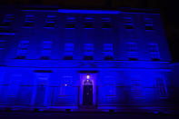 As part of the National Health Service (NHS) birthday celebrations 10 Downing Street, in London, is illuminated blue on Saturday evening, July 4, 2020. Saturday July 4, the day before the NHS birthday, has been designated as a chance for the nation to come together and pay respect. As part of this collective memorial, and as a mark of respect and tribute to NHS staff, essential workers and everyone who has played their part during the coronavirus pandemic, iconic landmarks were asked to be illuminated in blue. (Victoria Jones/PA via AP)