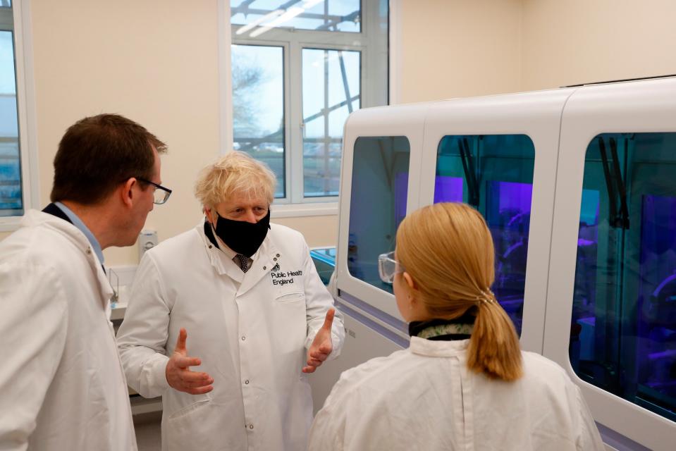 <p>Boris Johnson (C) views a PCR diagnostics machine with biomedical scientist Jodie Owen (R) and Director PHE Porton Down Alex Sienkiewicz (L)</p>AFP via Getty Images