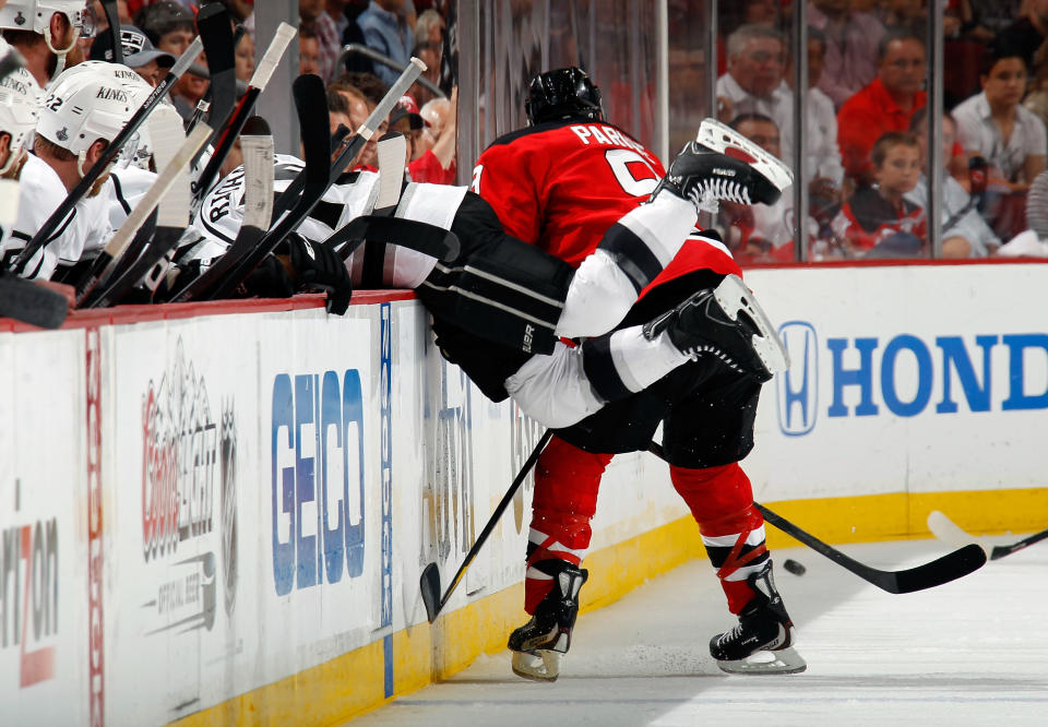 NEWARK, NJ - JUNE 09: Mike Richards #10 of the Los Angeles Kings falls into the bench as Zach Parise #9 of the New Jersey Devils makes contact during Game Five of the 2012 NHL Stanley Cup Final at the Prudential Center on June 9, 2012 in Newark, New Jersey. (Photo by Bruce Bennett/Getty Images)