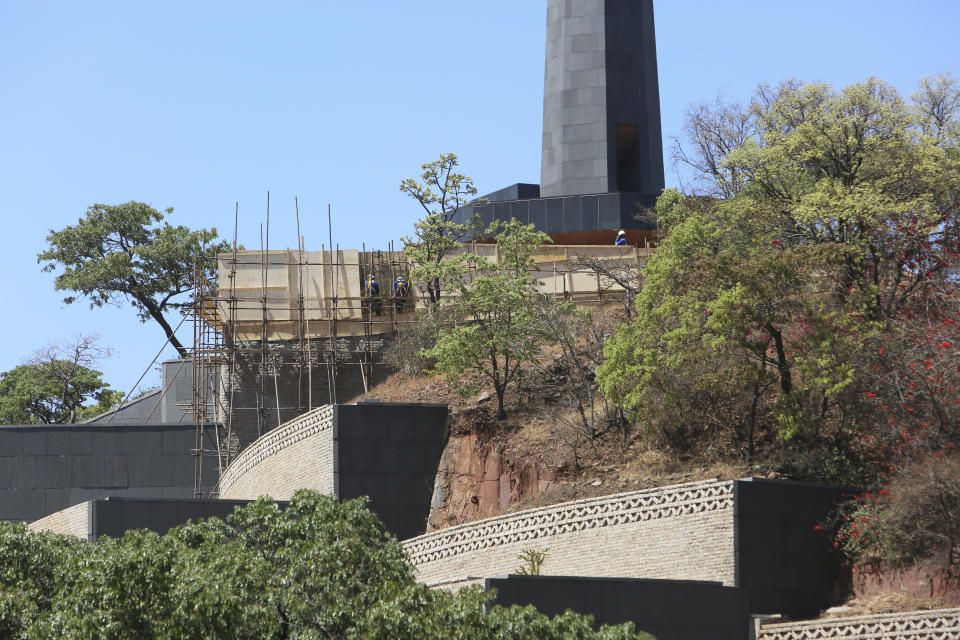 Construction of a mausoleum where former Zimbabwean President Robert Mugabe was supposed to be buried continues at the National Heroes Acre, in Harare, Friday, Sept, 27, 2019. Zimbabwe's former president Mugabe will now be buried at his rural home, according to a government spokesperson. Mugabe's burial location has been a source of mystery and contention since his death earlier this month at age 95 in Singapore. (AP Photo/Tsvangirayi Mukwazhi)