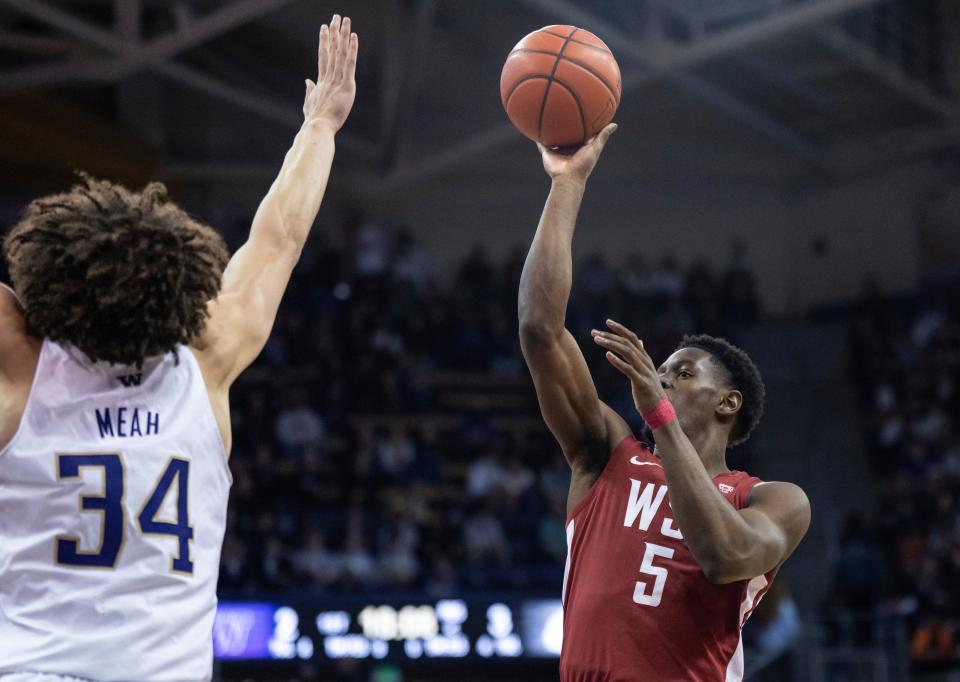 Washington State guard TJ Bamba shoots over Washington center Braxton Meah during the first half of an NCAA college basketball game Thursday, March 2, 2023, in Seattle. (AP Photo/Stephen Brashear)