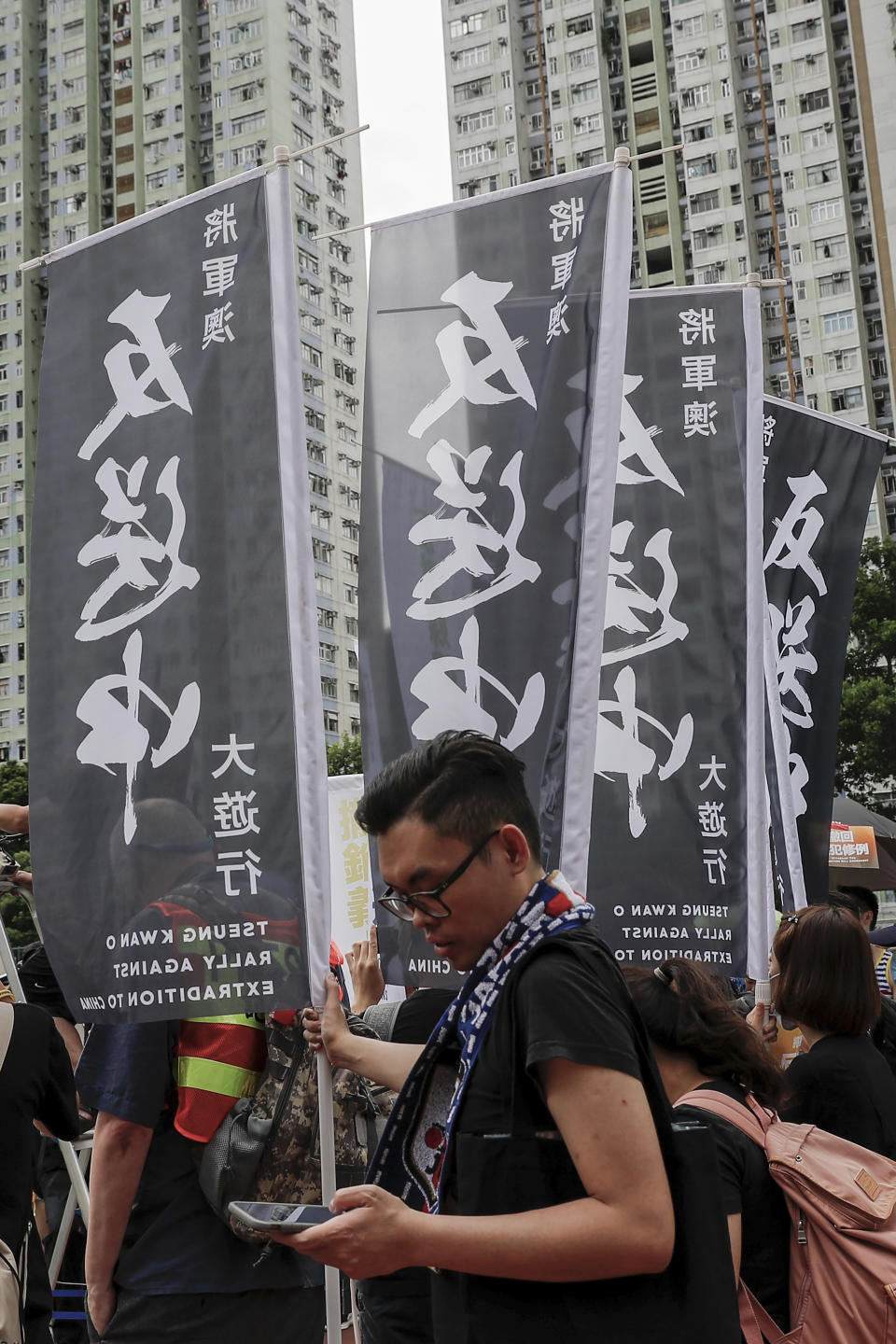 Protesters hold Anti-Extradition Bill banners as they take part in a march in Hong Kong, Sunday, Aug. 4, 2019. Hong Kong police said Sunday that they arrested more than 20 people for unlawful assembly, assault and other offences after confrontations between protesters and authorities continued deep into the night. (AP Photo/Vincent Thian)