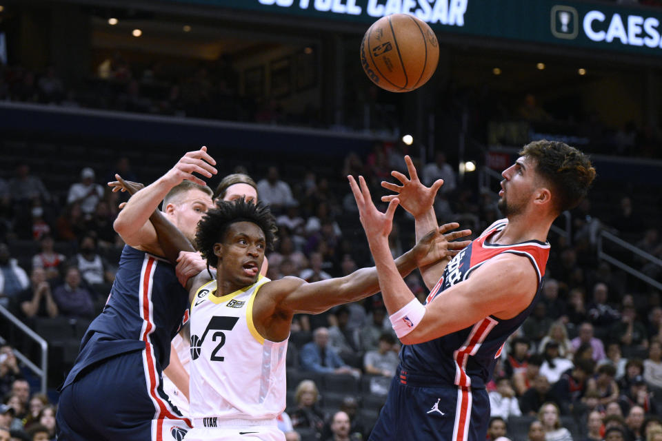 Utah Jazz guard Collin Sexton (2) competes for the ball against Washington Wizards forward Deni Avdija, right, and center Kristaps Porzingis, left, during the first half of an NBA basketball game Saturday, Nov. 12, 2022, in Washington. (AP Photo/Nick Wass)