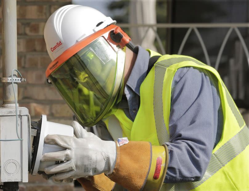 An energy technician replacing a standard electricity meter with a new &quot;smart&quot; meter in North Riverside, IL, January 2013