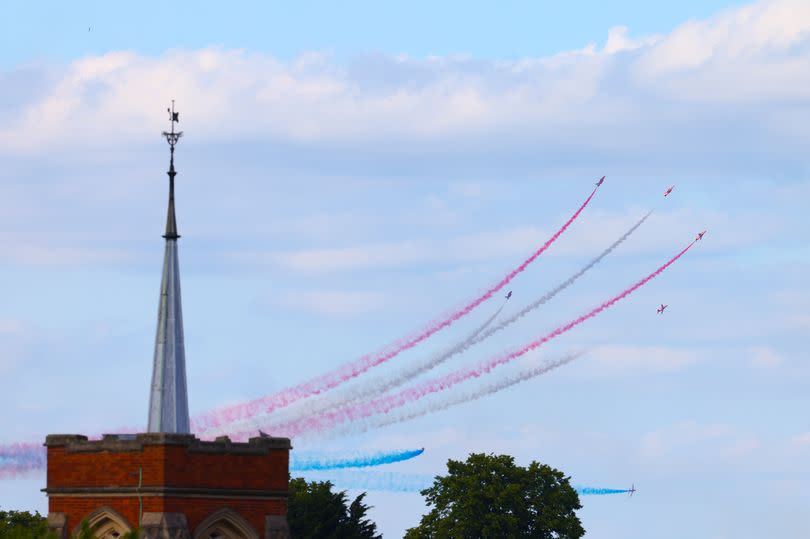 The Red Arrows in the sky producing coloured smoke