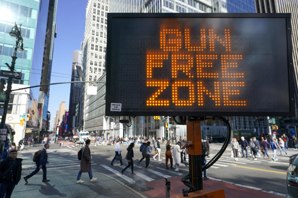 FILE - A traffic sign on the corner of 42nd Street and 6th Avenue announces Times Square as a gun free zone, Oct. 11, 2022, in New York. New York can continue to enforce laws banning firearms in sensitive locations, a federal appeals court ruled Friday, Dec. 8, 2023 in its first broad review of a host of new gun rules passed in the state after a landmark Supreme Court ruling last year. (AP Photo/Mary Altaffer, File)