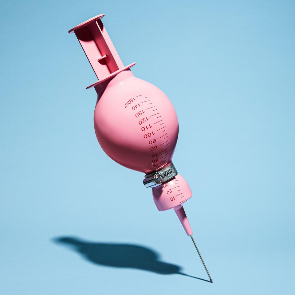 a pink syringe with the end tied up with a metal clip making the syringe bulge weight loss obesity