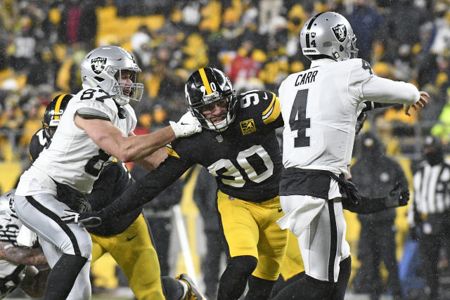 Las Vegas Raiders quarterback Derek Carr throws a pass under pressure  during the first half of an NFL football game against the Houston Texans,  Sunday, Oct. 23, 2022, in Las Vegas. (AP