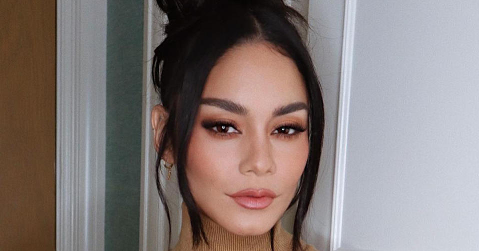 Vanessa Hudgens with her dark hair in an up do and heavy makeup