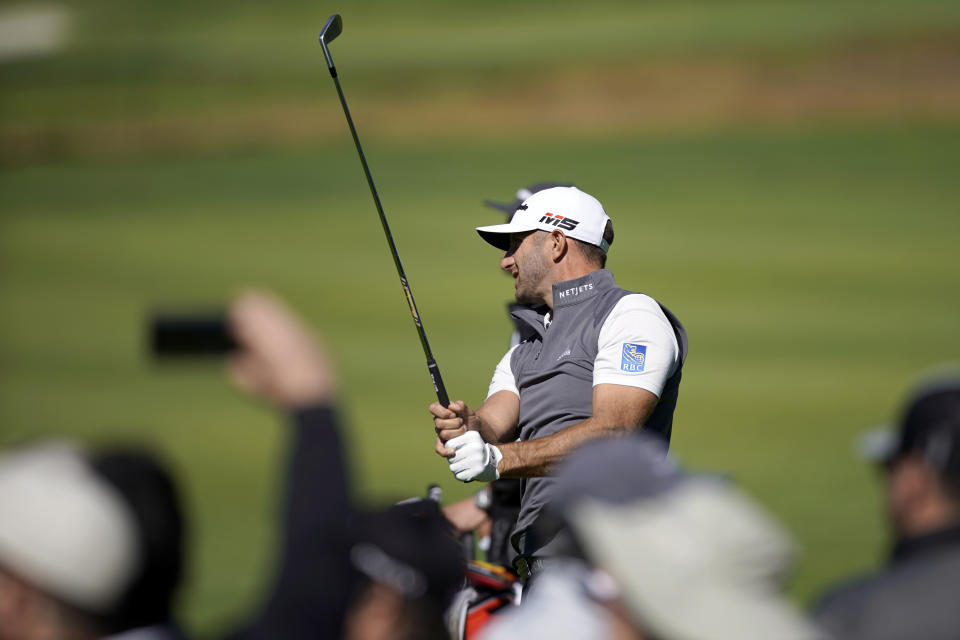Dustin Johnson watches his second shot on the 15th hole as second round play continues during the Genesis Open golf tournament at Riviera Country Club on Saturday, Feb. 16, 2019, in the Pacific Palisades area of Los Angeles. (AP Photo/Ryan Kang)