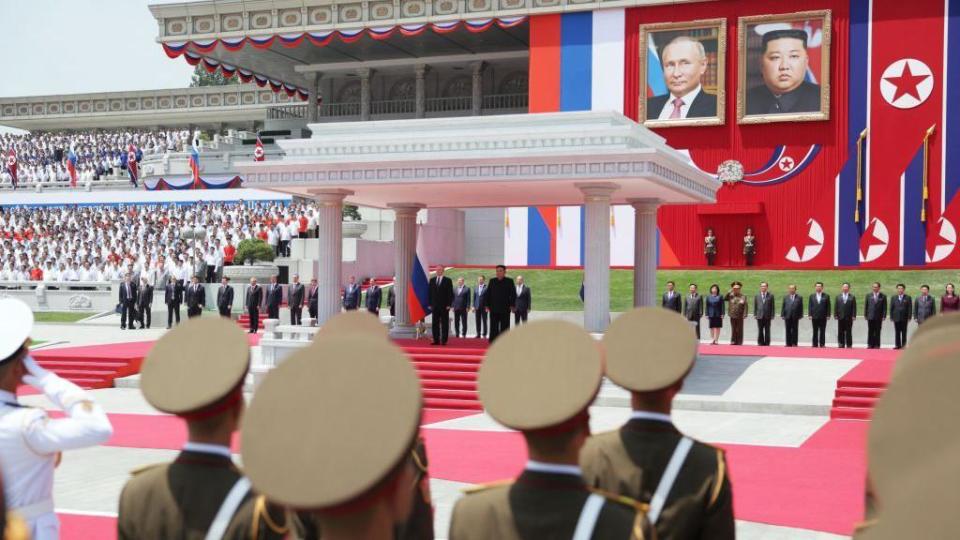 In this pool photograph distributed by the Russian state agency Sputnik, Russia's President Vladimir Putin (centre L) and North Korea's leader Kim Jong Un (centre R) attend a welcoming ceremony at Kim Il Sung Square in Pyongyang on June 19, 2024. 